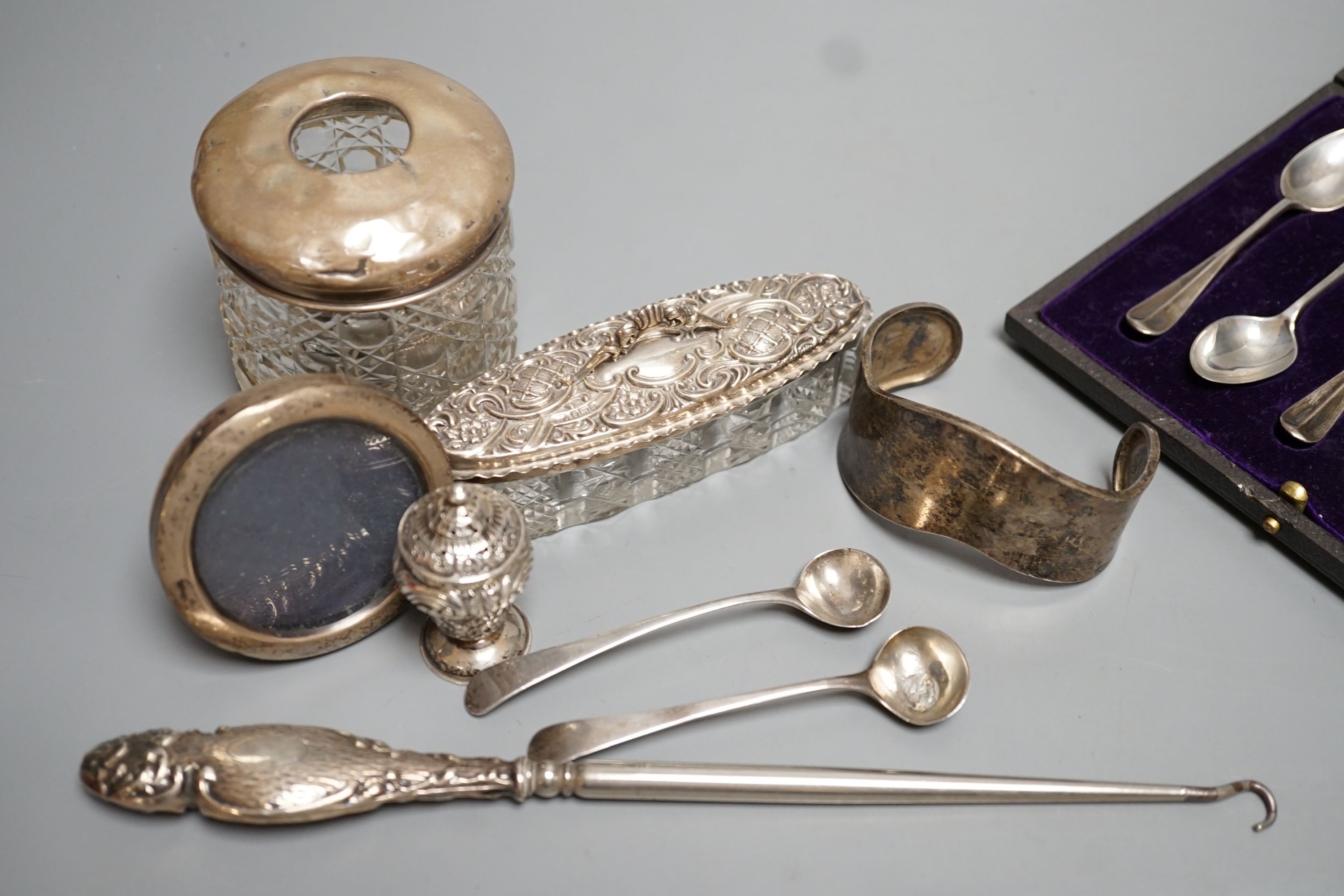 Mixed silver including a cased set of six silver teaspoons, small mounted photograph frame, condiment spoons, toilet jars, button hook, etc.